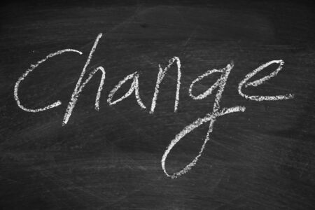 Change written on the blackboard with chalkの写真素材