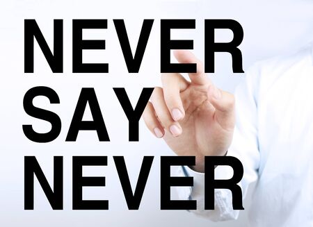Businessman is pointing the text Never Say Never on the virtual transparent screen.
