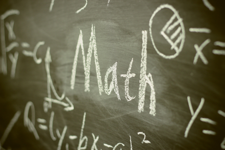 Math text with some maths formulas on chalkboard background.の写真素材
