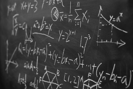 Maths formulas written by white chalk on the blackboard background.の写真素材
