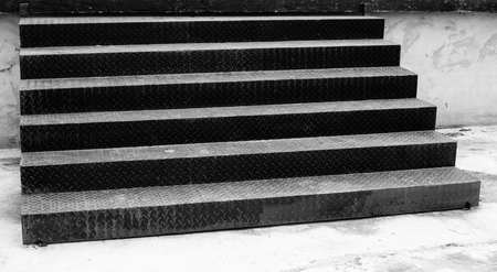 The wide black stairs steps is on the ground.の写真素材