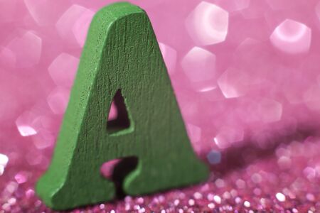 Letter A is standing on the glitter texture background.の写真素材