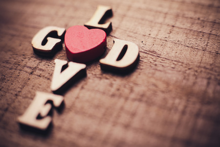 God is love concept text lying on the rustic wooden background.の写真素材