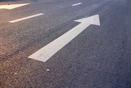Closeup photo of the road with white arrow.の写真素材
