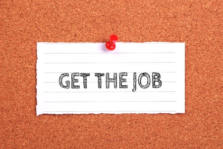 Get The Job note paper pinned on the cork background.の写真素材