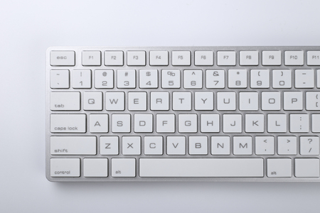 Closeup picture of computer keyboard with white background.