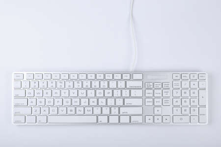 Closeup picture of computer keyboard with white background.