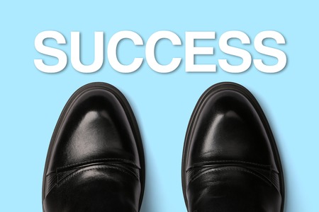 Top view of men shoes with text Success.の写真素材