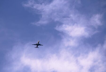 Plane flying in the blue sky with white cloud.の写真素材