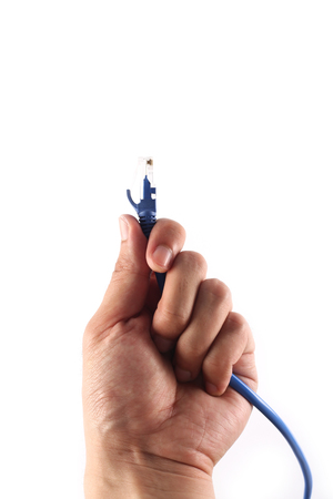 Network cable in hand is isolated on white background.の写真素材
