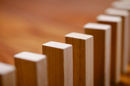 A lot of wooden block standing in a line. Domino Effect Conceptの写真素材