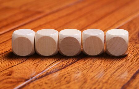 Wooden blocks are on the wooden floor background.