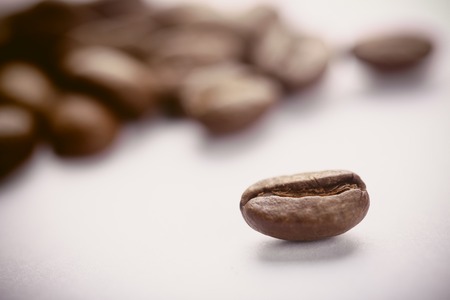 Some coffee beans are on the white background.の写真素材