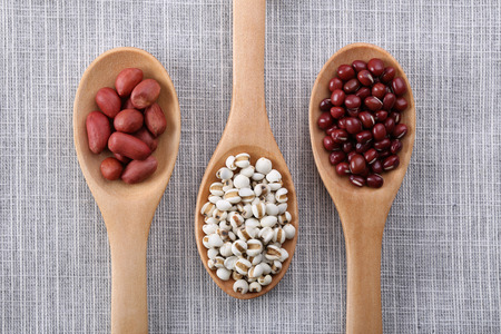 Many types of beans in wooden spoon.の写真素材