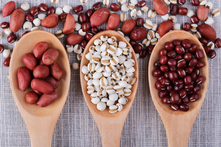 Many types of beans in wooden spoon.の写真素材
