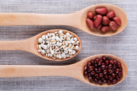Many types of beans in wooden spoon.の写真素材