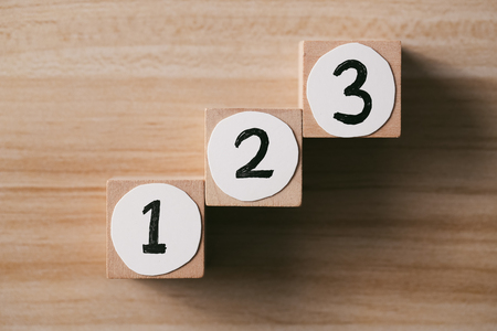 Step by step concept on the wooden desk background. Step 1, Step 2, Step 3 - the ladder to success.の写真素材