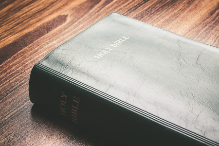 Holy bible on the wooden desk.