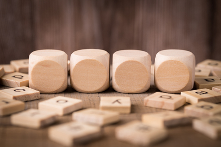 Wooden blocks on the table against old wooden background.の写真素材