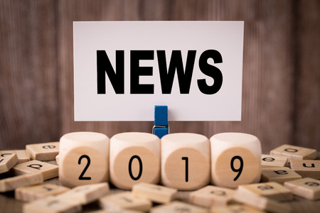News Concept with old wooden background.