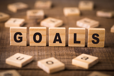 Goals Concept Wood Blocks with old wooden background.の写真素材