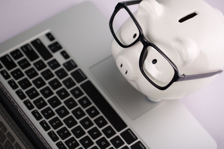 Piggy Bank With Laptop which means make money online or internet business concepts.の写真素材