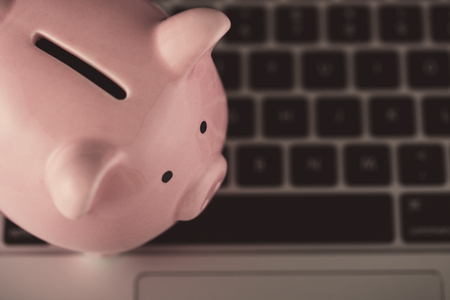 Piggy Bank With Laptop which means make money online or internet business concepts.の写真素材
