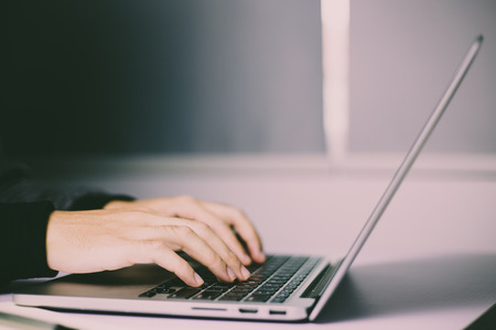 Man is typing on the laptop.