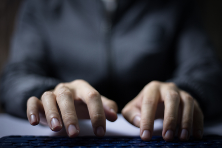 The man is typing on something.の写真素材