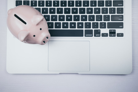 Top view of laptop with piggy bank.の写真素材