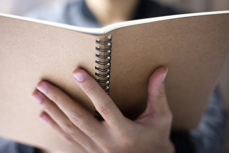 The man is reading the notebook.の写真素材