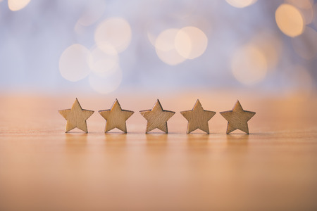 Wooden five star shape on table. The best excellent business services rating customer experience concept.の写真素材