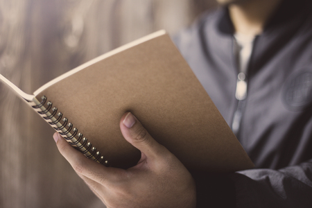 The man is scanning the notebook.の写真素材