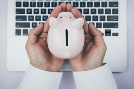Top view of laptop with piggy bank.の写真素材
