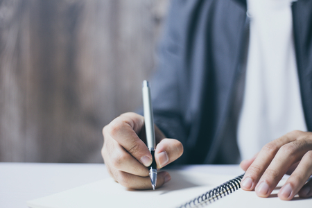 Man is writing on the blank notebook.の写真素材