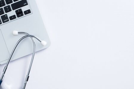 Doctor desk table with stethoscope and laptop computer, Top view with copy space, flat lay.