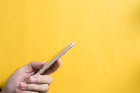 Smartphone with hand touching against blank bacoground.