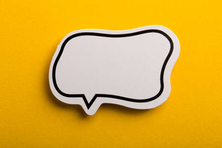 Blank white speech bubble isolated on yellow background.