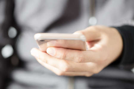 Close up shot of a man using mobile smart phone.