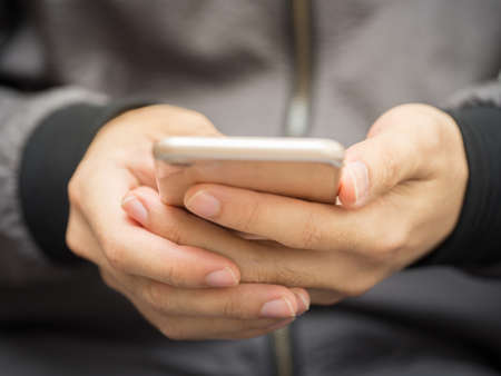 Close up shot of a man using mobile smart phone.