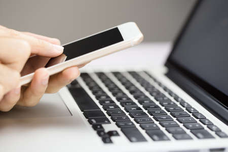 Businessman using smartphone and laptop writing on tablet, business concept, finance background and...
