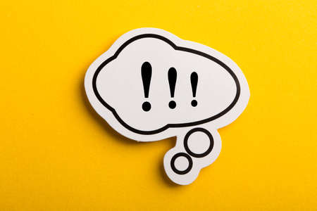 Exclamation Mark speech bubble isolated on yellow background.の写真素材