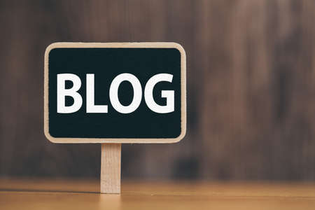 Blog Word Letters Sign against old wooden background.の写真素材