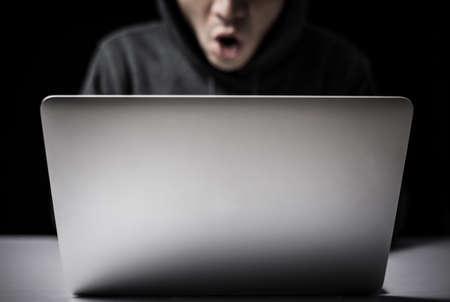 Hacker in front of the laptop computer.の写真素材