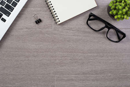 Wood office desk table top view with laptop and supplies.の写真素材