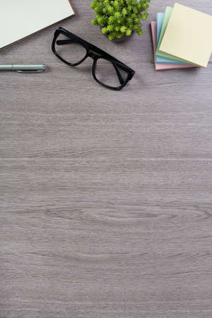 Wood office desk table top view with laptop and supplies.の写真素材