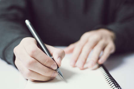Writing on the blank notebook with copy space.