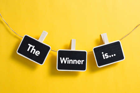 The Winner is concept small blackboard hanging on line.の写真素材