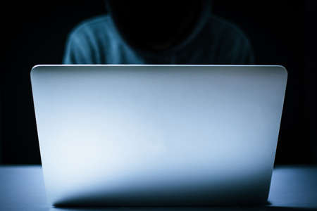 Hacker in front of the laptop computer.の写真素材