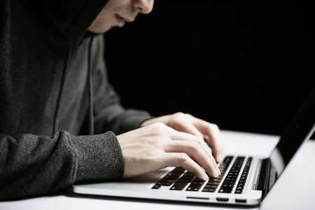 Hacker in front of the laptop computer.の写真素材